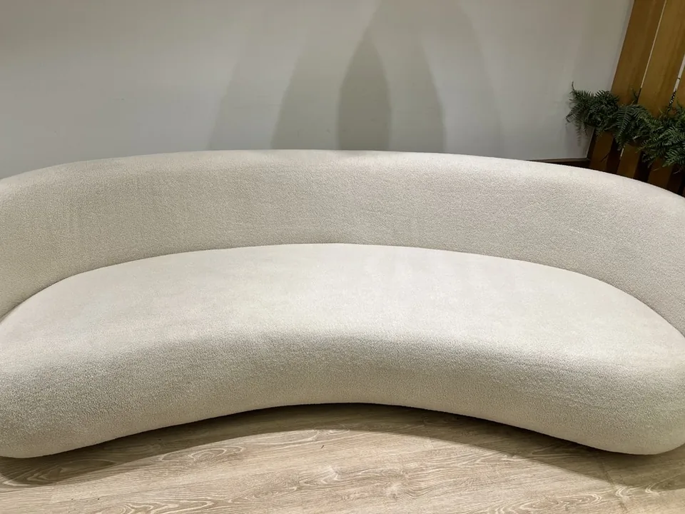 The curved cream sofa after upholstery cleaning